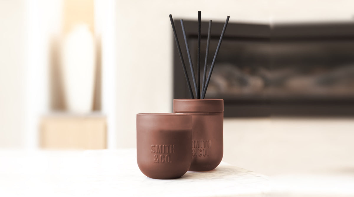 Smith & Co scented candle and reed diffuser in Black Oud & Saffron on a marble table